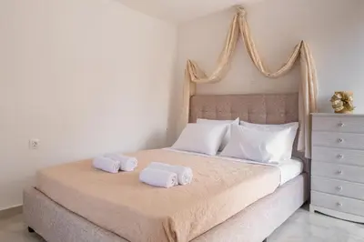 a bedroom with a bed with two towels on it at Majestic Marble Retreat in Rhodes Town