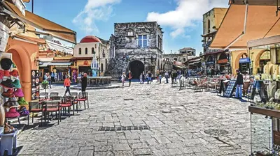 a group of people walking around a street in a city at Majestic Marble Retreat in Rhodes Town