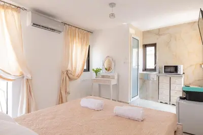 a bedroom with a bed with two towels on it at Majestic Marble Retreat in Rhodes Town