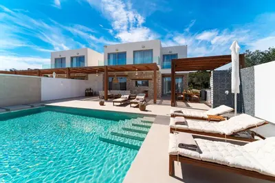 a villa with a swimming pool and a house at Luna Llena Villas in Afantou