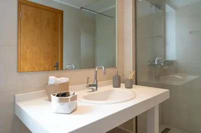 a bathroom with a sink and a mirror at Luna Llena Villas in Afantou