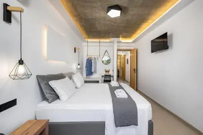 a bedroom with a large white bed in a room at ArmoniKon Pool Villas in Asgourou