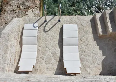 two white towels hanging on a wall at SALT RETREAT - Seafront Villa in Halki