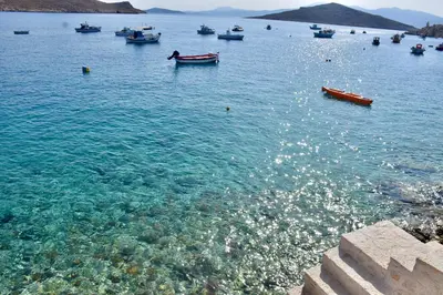 a group of boats in a large body of water at SALT RETREAT - Seafront Villa in Halki