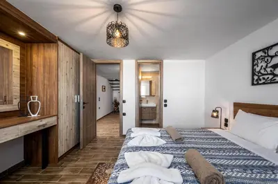 a bedroom with a bed with towels on it at Psychedelia Beach House in Gennadi
