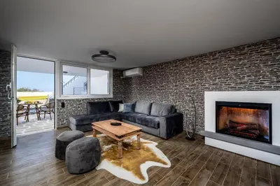 a living room with a couch and a fireplace at Psychedelia Beach House in Gennadi