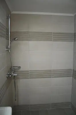 a shower with a glass door in a bathroom at Villa FLORA in Kattavía