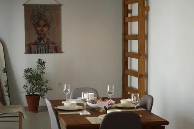 a dining room table with chairs and a painting on the wall at Villa FLORA in Kattavía