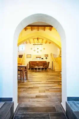 an arched hallway with a dining room and a table at Stefanis Relis House in Archangelos