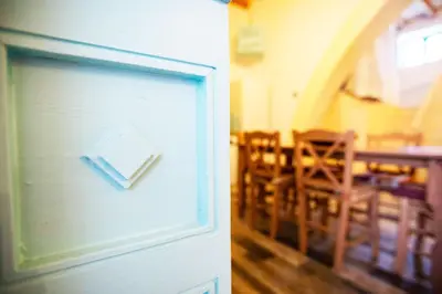 a door with a picture of a dining room at Stefanis Relis House in Archangelos