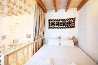 a small room with a bed on a balcony at Stefanis Relis House in Archangelos