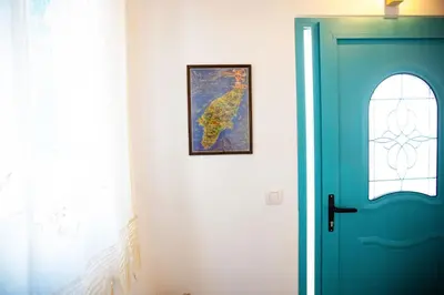 a door in a room with a map on the wall at Stefanis Relis House in Archangelos