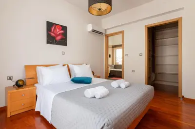 a bedroom with a white bed with towels on it at Cielo Blu villa in Soroni