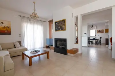 a living room with a couch and a coffee table at Cielo Blu villa in Soroni