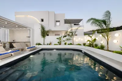 a swimming pool in the backyard of a house at Mylos Luxury Escape Villa in Faliraki