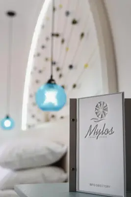 a sign on a table in a room with a bed at Mylos Luxury Escape Villa in Faliraki