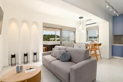 a living room with a couch and a table at Mylos Luxury Escape Villa in Faliraki
