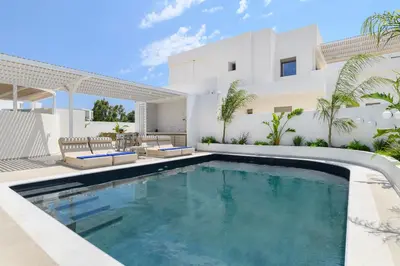 a swimming pool in the backyard of a house at Mylos Luxury Escape Villa in Faliraki