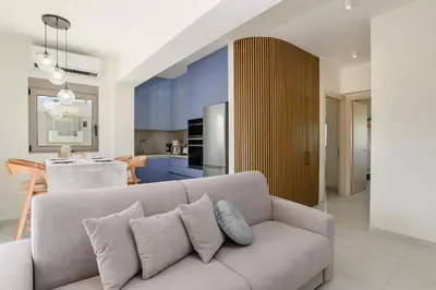 a living room with a couch and a kitchen at Mylos Luxury Escape Villa in Faliraki