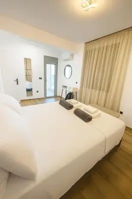 a large white bed with two pillows on it at Lihi's Sea View in Rhodes in Rhodes Town