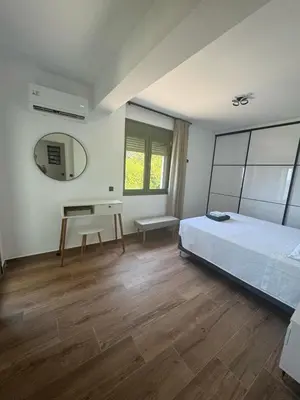 a bedroom with a bed and a desk and a mirror at Lihi's Sea View in Rhodes in Rhodes Town