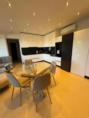 a living room with a glass table and chairs at Lihi's Sea View in Rhodes in Rhodes Town