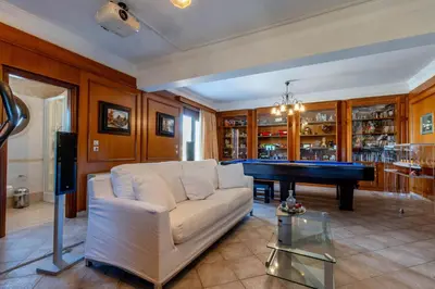 a living room with a couch and a pool table at Onda Vista Luxury Villa in Kremasti