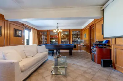 a living room with a couch and a pool table at Onda Vista Luxury Villa in Kremasti