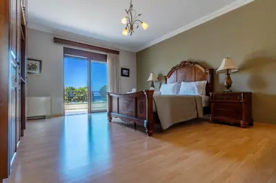 a bedroom with a bed and a large window at Onda Vista Luxury Villa in Kremasti
