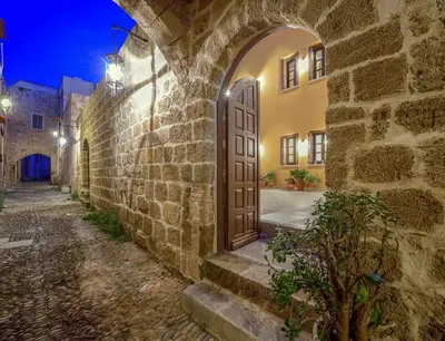 an entrance to an old stone building with a wooden door at Spanish Knights Inn in Rhodes Town