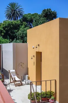 a patio with a chair and a building at Spanish Knights Inn in Rhodes Town