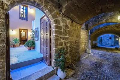 an entrance to a building with arches and a door at Spanish Knights Inn in Rhodes Town