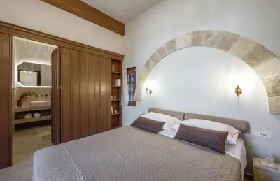 a bedroom with a large bed with an arch above it at Spanish Knights Inn in Rhodes Town