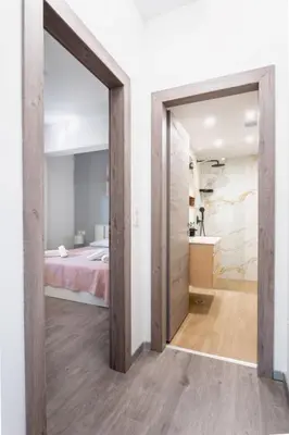 a pivot door in a bedroom with a bed at Cozy Guesthouse in Koskinou
