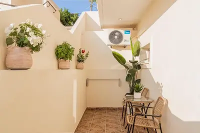 a small balcony with potted plants on the wall at Cozy Guesthouse in Koskinou