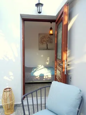 a room with a mirror and a chair and a bed at Lilly's Cosy Studio in Rhodes Town