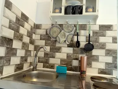 a kitchen with a sink and a counter top at Lilly's Cosy Studio in Rhodes Town