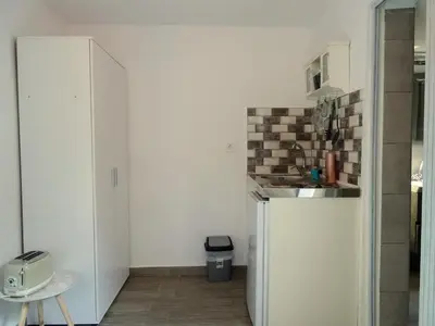 a kitchen with a sink and a refrigerator at Lilly's Cosy Studio in Rhodes Town