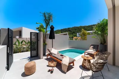 a patio with a swimming pool on a house at Afesou Suites in Ialyssos