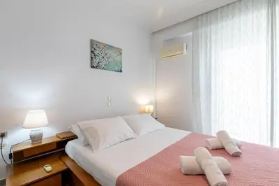 a bedroom with a large bed with two towels on it at Micasa Shiny Apartment in Rhodes Town
