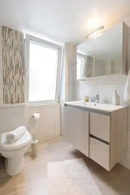 a bathroom with a toilet and a sink and a window at Micasa Shiny Apartment in Rhodes Town