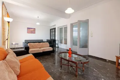 a living room with a couch and a table at Micasa Shiny Apartment in Rhodes Town