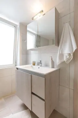 a white bathroom with a sink and a mirror at Micasa Shiny Apartment in Rhodes Town