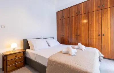 a bedroom with a bed with two towels on it at Micasa Shiny Apartment in Rhodes Town