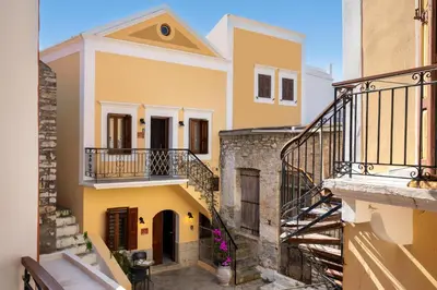 a view of a house with a staircase at Aelius Apartments in Symi