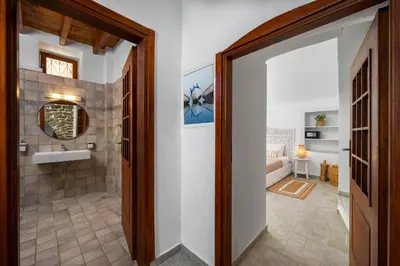 a bathroom with a tub and a sink in a room at Aelius Apartments in Symi