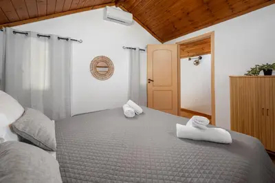 a bedroom with a bed with towels on it at Aelius Apartments in Symi