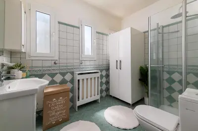 a bathroom with a toilet and a sink and a shower at Excelencia New Villa with Artistic Pool & Sea View in Asgourou