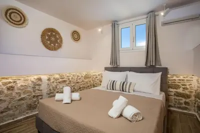 a bedroom with a large bed with towels on it at Villa Gemma 2 next to Faliraki in Kalithies