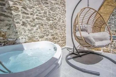 a wicker chair sitting in a bath tub at Villa Gemma 2 next to Faliraki in Kalithies